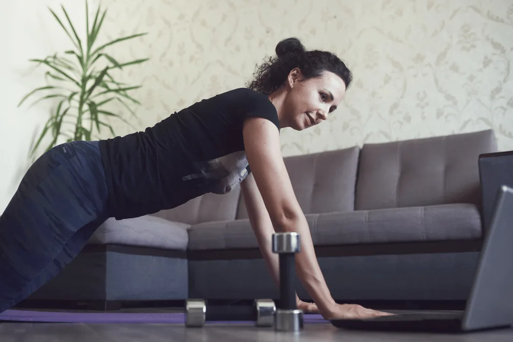 Certified personal trainer conducting one-on-one home fitness training